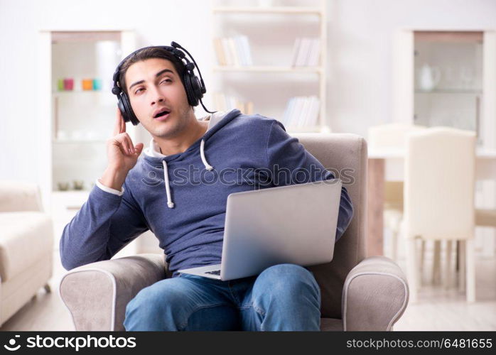 Young handsome man listening to music with headphones