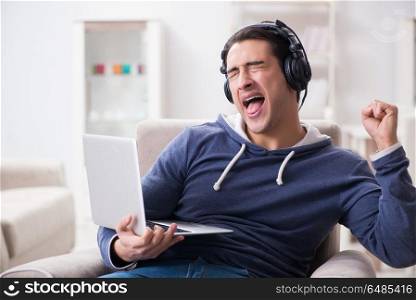 Young handsome man listening to music with headphones