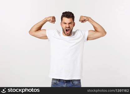 Young handsome man over isolated background Punching fist to fight, aggressive and angry attack, threat and violence.. Young handsome man over isolated background Punching fist to fight, aggressive and angry attack, threat and violence