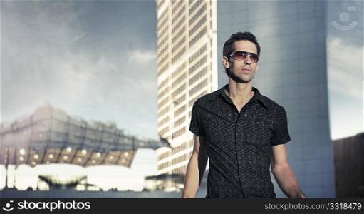 Young handsome man over urban background