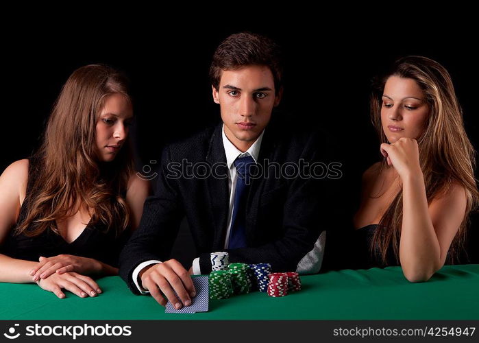 Young handsome man playing texas hold&acute;em poker