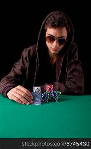 Young handsome man playing texas hold&acute;em poker