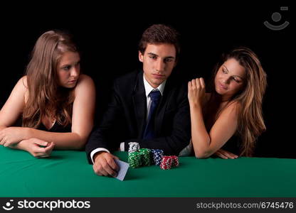 Young handsome man playing texas hold&acute;em poker