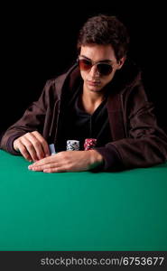 Young handsome man playing texas hold&acute;em poker