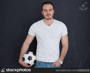 young handsome man playing with soccer ball isolated over grey background
