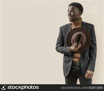 young handsome man posing with hat 13