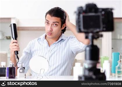 Young handsome man recording his blog in hygiene concept 