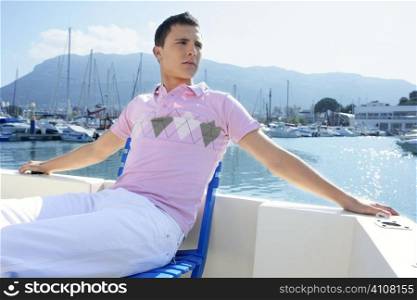 Young handsome man relaxed in vacation on a boat deck