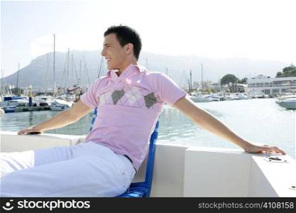 Young handsome man relaxed in vacation with his boat