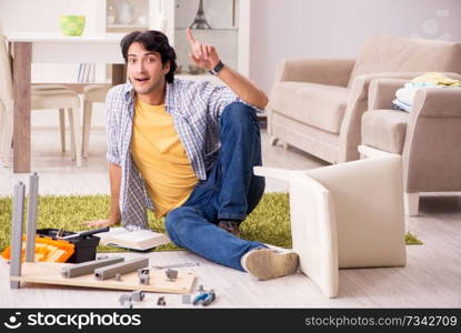 Young handsome man repairing chair at home 