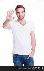 Young handsome man requiring stop with his hand - isolated on white.