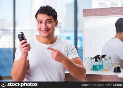 Young handsome man shaving in the morning
