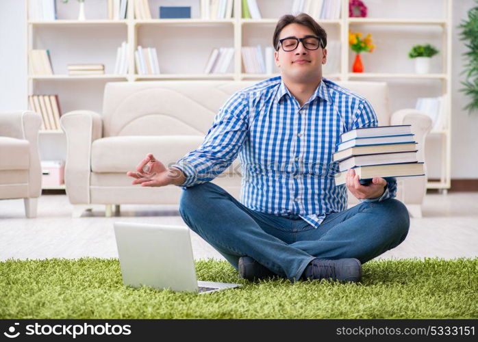 Young handsome man sitting on floor at home