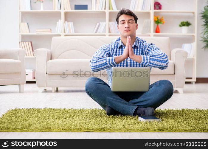 Young handsome man sitting on floor at home