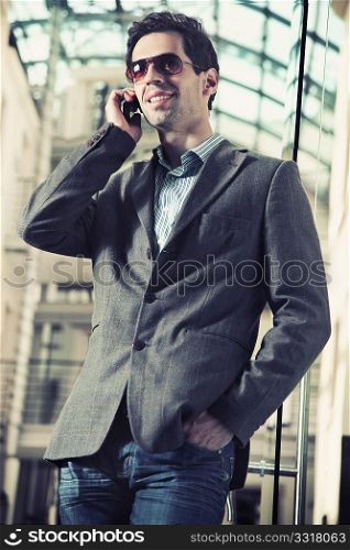 Young handsome man talking over cellphone