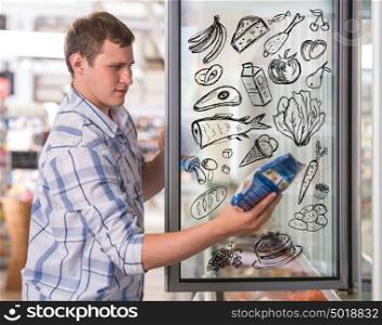 Young handsome man thinking of healthy food while shopping at grocery store closeup portrait and sketches overhead