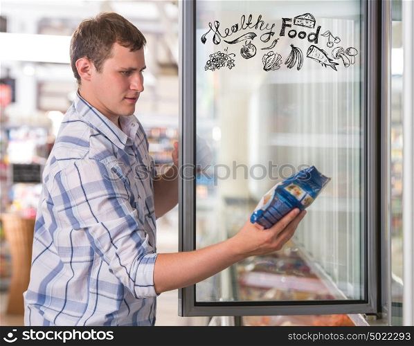 Young handsome man thinking of healthy food while shopping at grocery store closeup portrait and sketches overhead