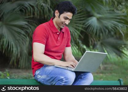Young handsome man using laptop