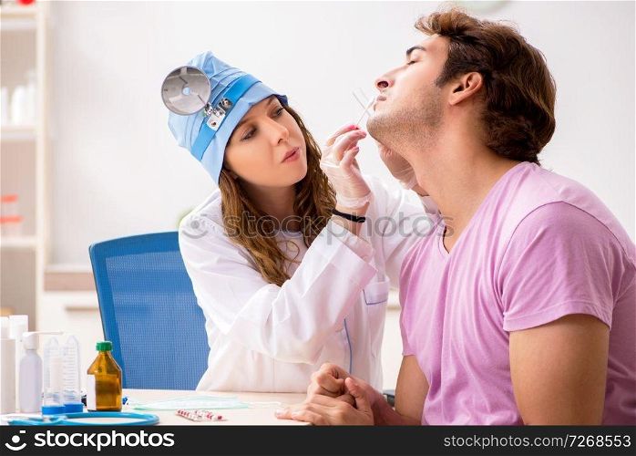 Young handsome man visiting young female doctor otolaryngologist