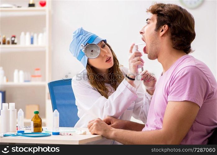 Young handsome man visiting young female doctor otolaryngologist