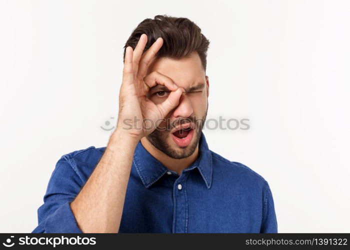 Young handsome man with beard doing ok gesture shocked with surprised face, eye looking through fingers. Unbelieving expression. Young handsome man with beard doing ok gesture shocked with surprised face, eye looking through fingers. Unbelieving expression.