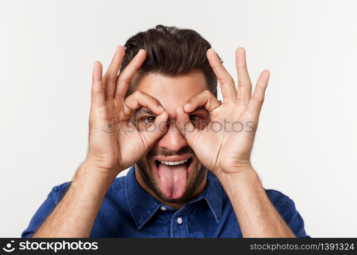Young handsome man with beard doing ok gesture shocked with surprised face, eye looking through fingers. Unbelieving expression. Young handsome man with beard doing ok gesture shocked with surprised face, eye looking through fingers. Unbelieving expression.