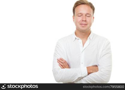 Young handsome man with closed eyes isolated on white background. He dreaming or relaxing with arms crossed on the chest