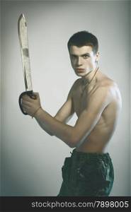 young handsome man with machete in hand