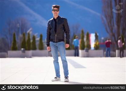 young handsome man with modern fashion leather jacket and style sunglasses
