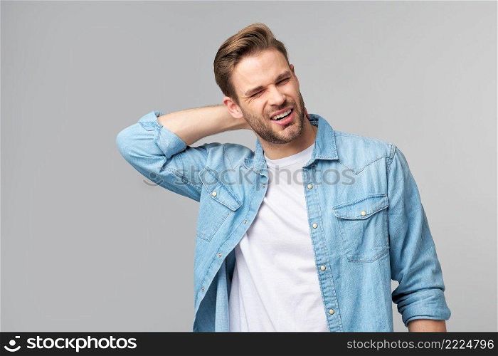 young handsome man with neck paint standing over grey background.. young handsome man with neck paint standing over grey background