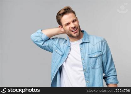 young handsome man with neck paint standing over grey background.. young handsome man with neck paint standing over grey background