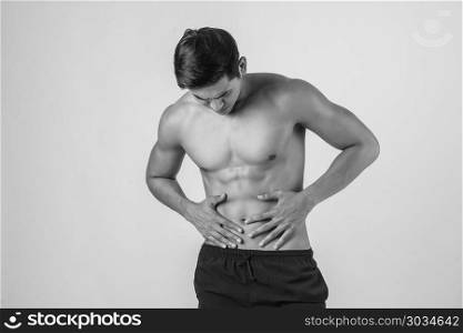 Young handsome Muscular man has abdominal pain isolated on white background.. Young handsome Muscular man has abdominal pain isolated on white
