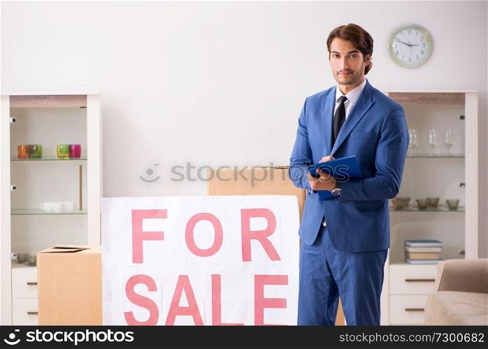 Young handsome realtor selling flat 