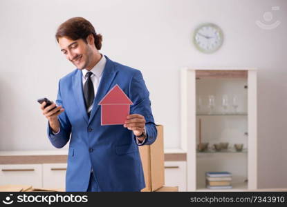 Young handsome realtor selling flat