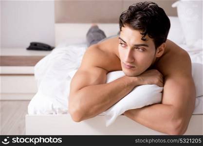 Young handsome shirtless guy showing nude torso sexy on bed at h. Young handsome shirtless guy showing nude torso sexy on bed at home