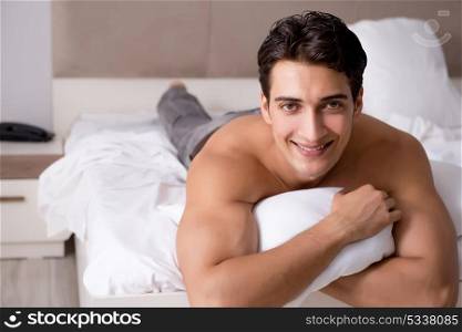 Young handsome shirtless guy showing nude torso sexy on bed at h. Young handsome shirtless guy showing nude torso sexy on bed at home