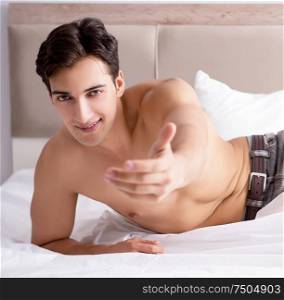 Young handsome shirtless guy showing nude torso sexy on bed at home. Young handsome shirtless guy showing nude torso sexy on bed at h