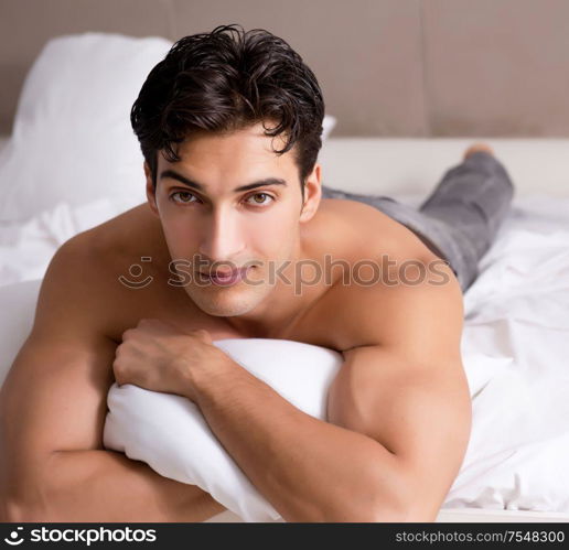 Young handsome shirtless guy showing nude torso sexy on bed at home. Young handsome shirtless guy showing nude torso sexy on bed at h