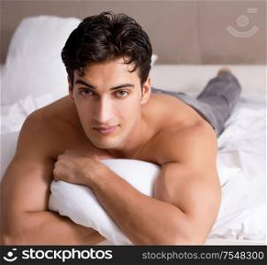 Young handsome shirtless guy showing nude torso sexy on bed at home. Young handsome shirtless guy showing nude torso sexy on bed at h