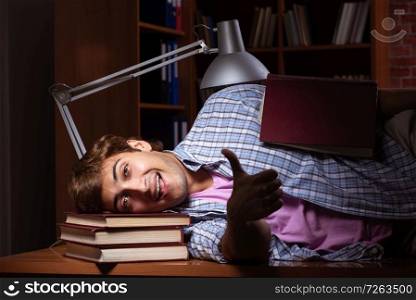 Young handsome student preparing for exams at night . The young handsome student preparing for exams at night 