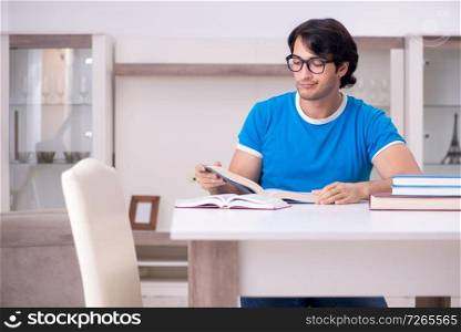 Young handsome student studying at home 
