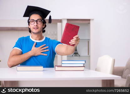 Young handsome student studying at home 