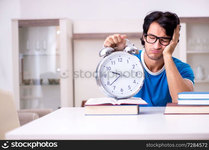 Young handsome student studying at home 