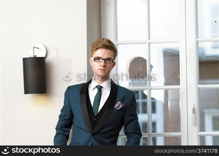 Young handsome stylish man fashion model posing in trendy cafe /restaurant