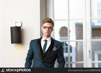 Young handsome stylish man fashion model posing in trendy cafe /restaurant