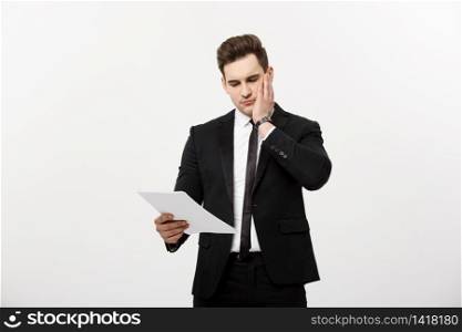 Young hansome businessman with a document in his hands isolated over white background. Young hansome businessman with a document in his hands isolated over white background.