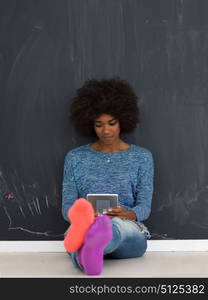 Young Happy African American Woman Using Digital Tablet Isolated on a gray background