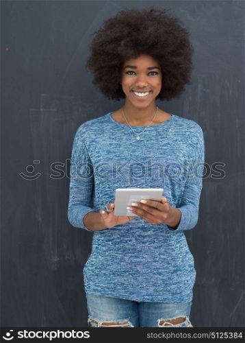 Young Happy African American Woman Using Digital Tablet Isolated on a gray background
