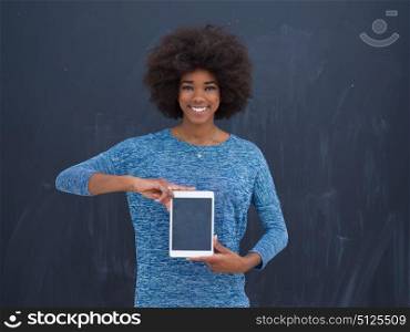 Young Happy African American Woman Using Digital Tablet Isolated on a gray background