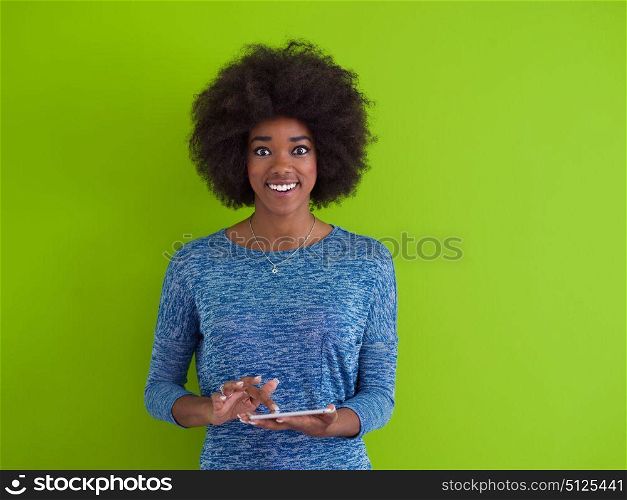 Young Happy African American Woman Using Digital Tablet Isolated on a green background